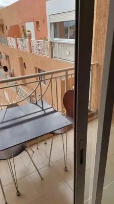 a table and a chair on a balcony at appartement 29 entier avec balcon in Marrakech