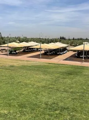 a row of tents with tables and a grass field at Les Jardin d'Atlas golf and Waky with private Pool in Marrakech