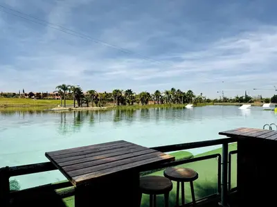 a view of a river with two stools and a table at Les Jardin d'Atlas golf and Waky with private Pool in Marrakech