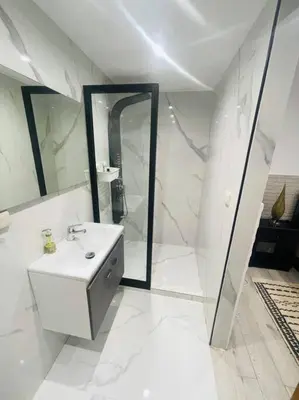 a white bathroom with a sink and a mirror at Les Jardin d'Atlas golf and Waky with private Pool in Marrakech