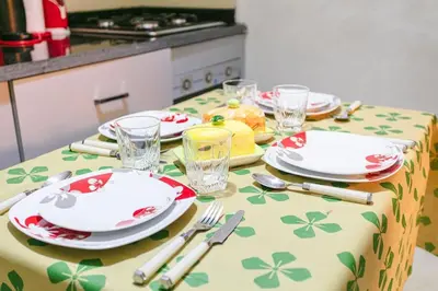 a table with plates and forks and glasses on it at Guéliz Cosy apart 2 Bedrooms in Marrakech