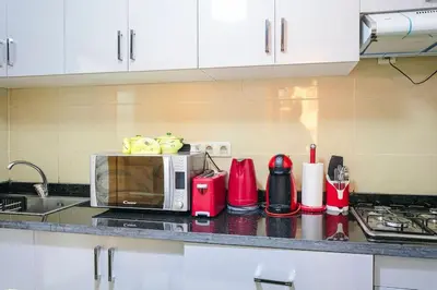 a kitchen with a counter top with a microwave at Guéliz Cosy apart 2 Bedrooms in Marrakech