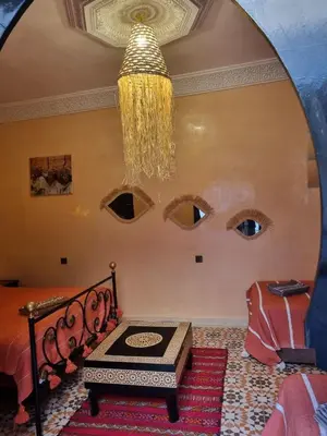 a room with a chandelier hanging from the ceiling at Riad Benrahal in Marrakech