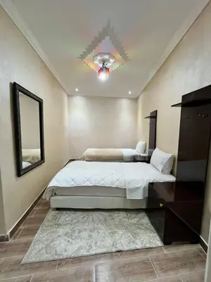 a bedroom with a large bed and a mirror at Riad 052 in Marrakech