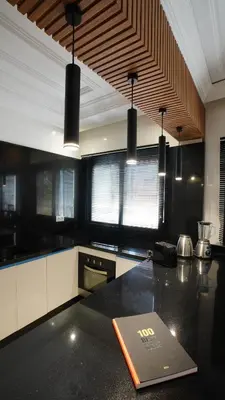a kitchen with a counter with a book on it at Appartement Neuf Carré EDEN in Marrakech