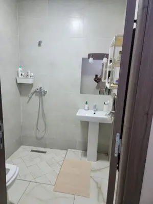 a bathroom with a sink and a toilet and a mirror at Magnifique appartement luxueux à 10mn du centre in Marrakech