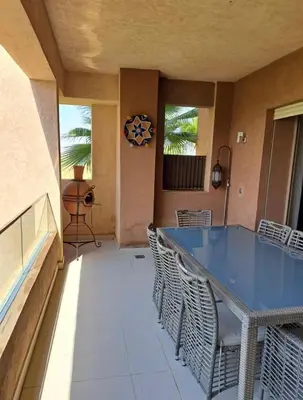 a dining room with a blue table and chairs at Luxury 2 bedroom flat Center Marrakesh in Marrakech