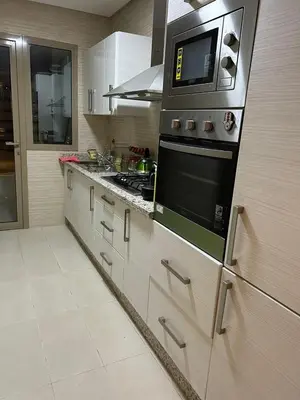 a kitchen with a stove and a microwave at Luxury 2 bedroom flat Center Marrakesh in Marrakech