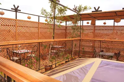 a balcony with a patio with tables and chairs at Riad marrakesh peace in Marrakech