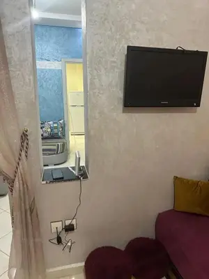 a flat screen tv on the wall of a bedroom at Spacious Apartment in Menara, 80 m² with View in Marrakech