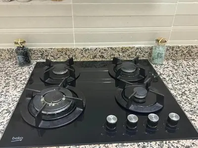 a stove top with four burners on a counter at Spacious Apartment in Menara, 80 m² with View in Marrakech
