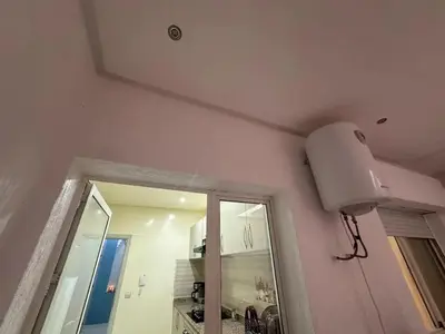 a light on the wall of a room with a mirror at Spacious Apartment in Menara, 80 m² with View in Marrakech