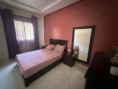 a bedroom with a bed and a mirror at Spacious Apartment in Menara, 80 m² with View in Marrakech