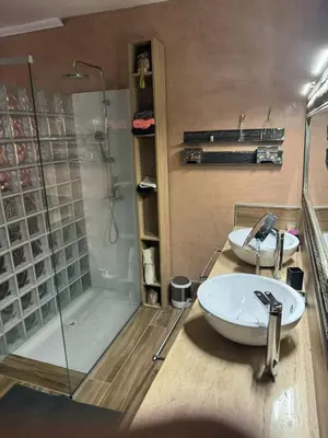 a bathroom with two sinks and a shower at riad didimora in Marrakech