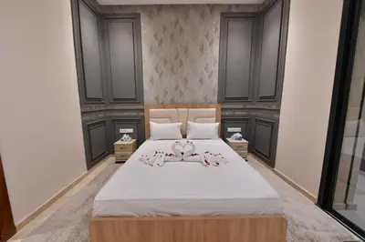 a bedroom with a large bed with two dolls on it at villa noria golf 4 chambres centre ville in Marrakech