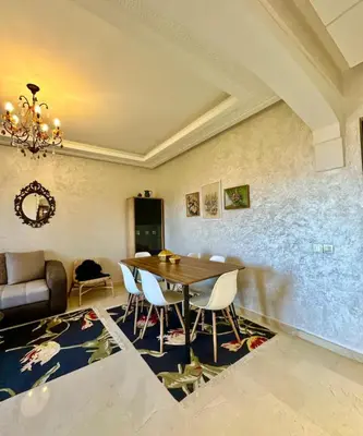 a dining room with a table and chairs at Hosted by Zakia in Marrakech