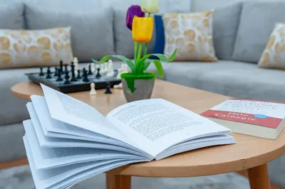 an open book on a coffee table with a chessboard at New elegant apartment with 2 bedroom in Marrakech