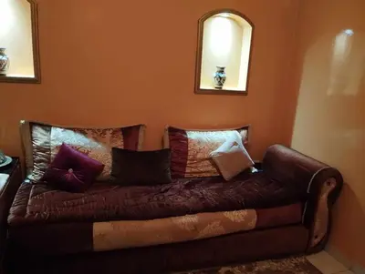 a brown couch with pillows on it in a room at zone 44 Massira 3 in Marrakech
