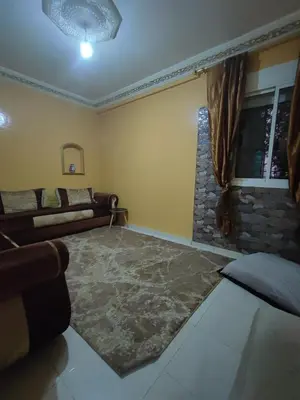 a living room with a couch and a window at zone 44 Massira 3 in Marrakech