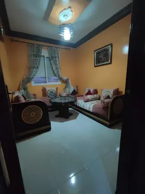 a living room with a couch and a table at zone 44 Massira 3 in Marrakech