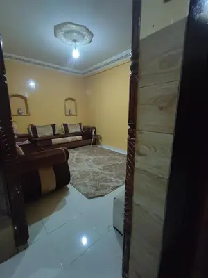 a living room with two beds in a room at zone 44 Massira 3 in Marrakech