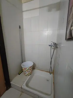 a small bathroom with a bucket in the corner at zone 44 Massira 3 in Marrakech