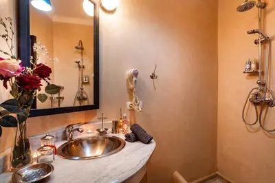 a bathroom with a sink and a mirror at Riad Dar Haris in Marrakech