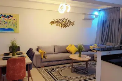 a living room with a couch and a table at Appartement familial de luxe in Marrakech