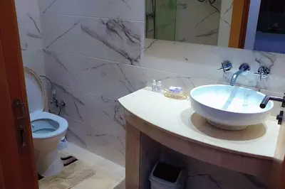 a bathroom with a sink and a toilet at Appartement familial de luxe in Marrakech