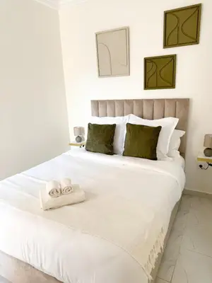 a bedroom with a white bed with towels on it at Lyana Home in Marrakech