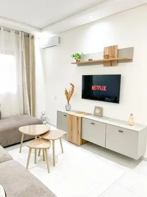 a living room with a tv on a wall at Lyana Home in Marrakech