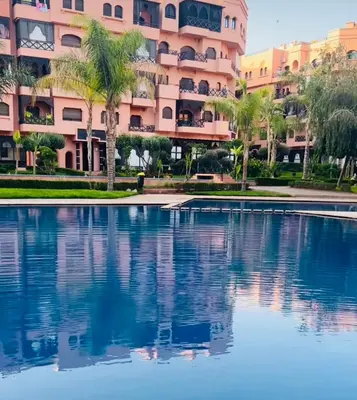 a swimming pool in front of a large apartment building at Premium Stay in Marrakech