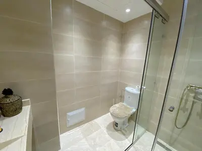 a bathroom with a toilet and a glass shower at Premium Stay in Marrakech
