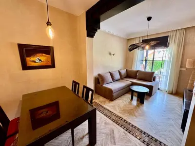 a living room with a couch and a table at Garden Villa-Style Retreat with Patio, BBQ & Pools in Marrakech