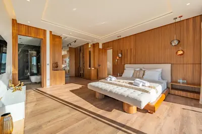 a bedroom with a large bed and a bench at Villa Talia, Luxury Stay, Golf & Lake View in Marrakech