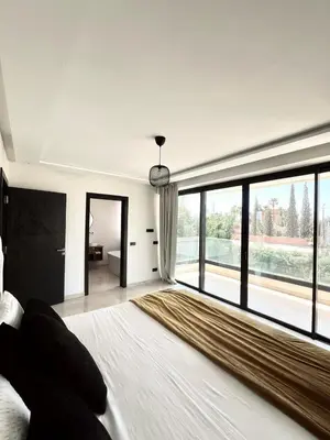a bedroom with a large bed with a large window at villa white in Marrakech