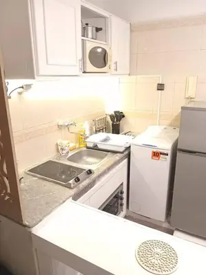 a small kitchen with a sink and a refrigerator at appartement de luxe marrakech in Marrakech