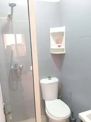 a white bathroom with a toilet and a shower at appartement de luxe marrakech in Marrakech