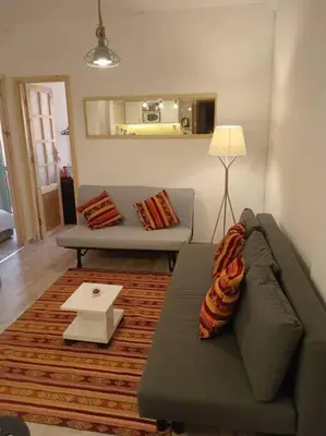 a living room with a couch and a table at appartement de luxe marrakech in Marrakech
