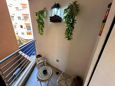a balcony with plants on the wall of a building at Les marguerites avec piscine près du jardin majorelle in Marrakech