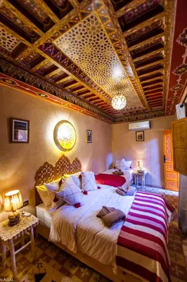 a bedroom with two beds and a ceiling at Riad Almonds Marrakech in Marrakech
