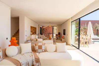 a living room with white furniture and a large window at Dar Al Jenna - Villa de luxe avec piscine privée in Marrakech