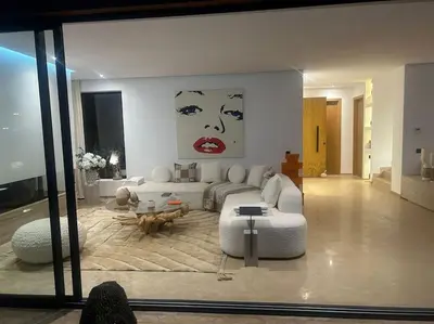 a living room with a couch and a table at Dar Al Jenna - Villa de luxe avec piscine privée in Marrakech