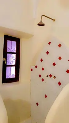 a bathroom with a shower with a window at Authentique riad Emplacement exceptionnel in Marrakech