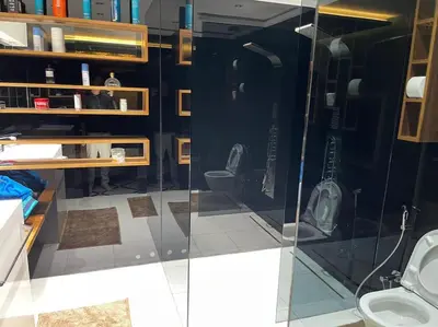 a bathroom with a glass shower and two toilets at Appart 2 chambres luxe contemporain hivernage in Marrakech