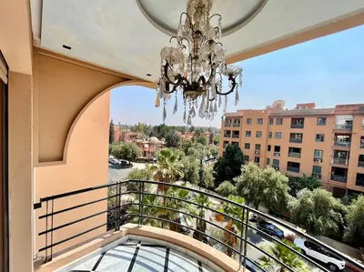 a chandelier hangs from a balcony in a building at Appart 2 chambres luxe contemporain hivernage in Marrakech