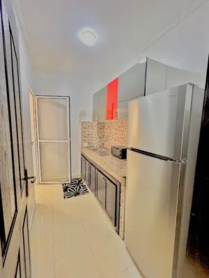 a kitchen with a refrigerator and a counter top at Le Paradise- Cosy, doux et Proche Centre in Marrakech