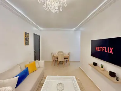 a living room with a couch and a table at Le Paradise- Cosy, doux et Proche Centre in Marrakech