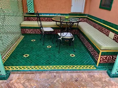 a patio with a table and chairs on a balcony at Riad Sofia in Marrakech