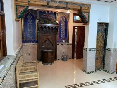 a large room with blue and white tiles on the walls at Maison d'hôtes Marrakech in Marrakech